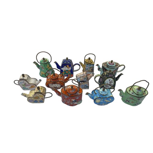 293 - Twelve Enamel hand painted Trade+Aid collectable small tea pots , approximately 9cm tall. No obvious... 