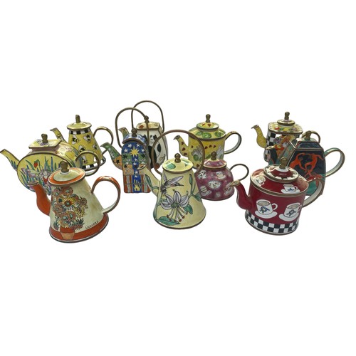 296 - Eleven Enamel hand painted Trade+Aid collectable small tea pots , approximately 9cm tall. No obvious... 