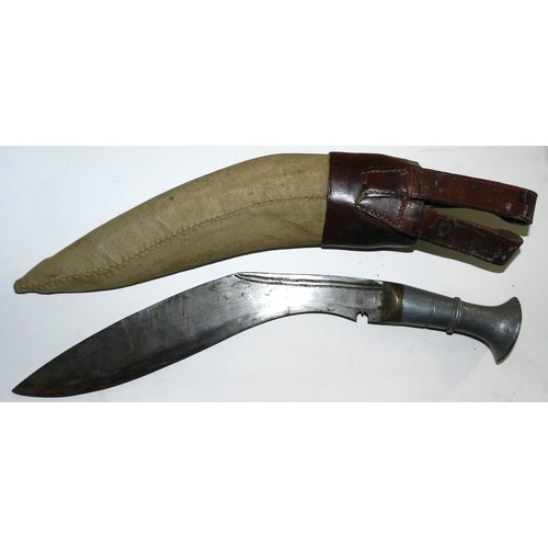 45 - WW II era kukri. Metal grip. 12 in. blade, some rust. Military frog, sheath covered.
Given by a Gurk... 