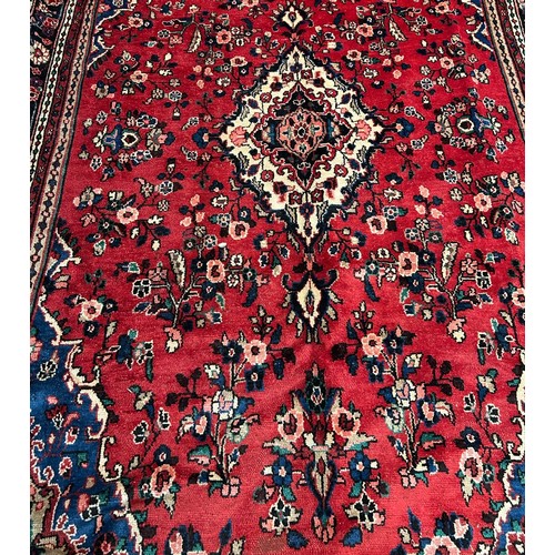 343 - Persian red ground sarouk carpet. Traditional floral, full pile village carpet