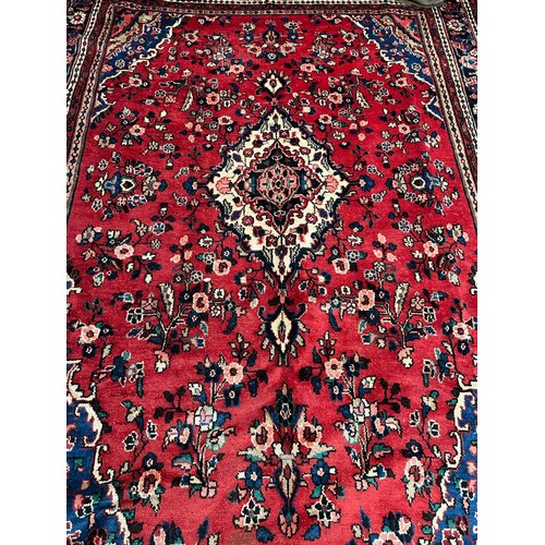 343 - Persian red ground sarouk carpet. Traditional floral, full pile village carpet