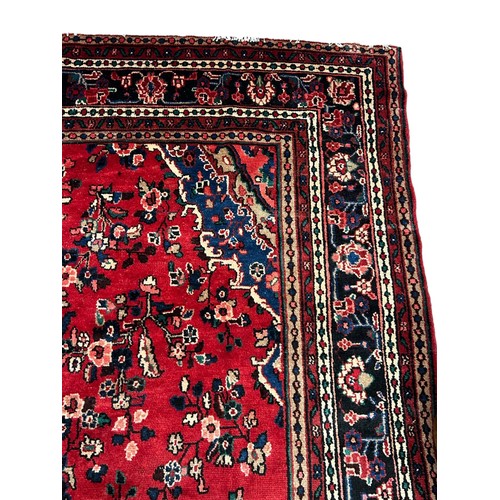 343 - Persian red ground sarouk carpet. Traditional floral, full pile village carpet