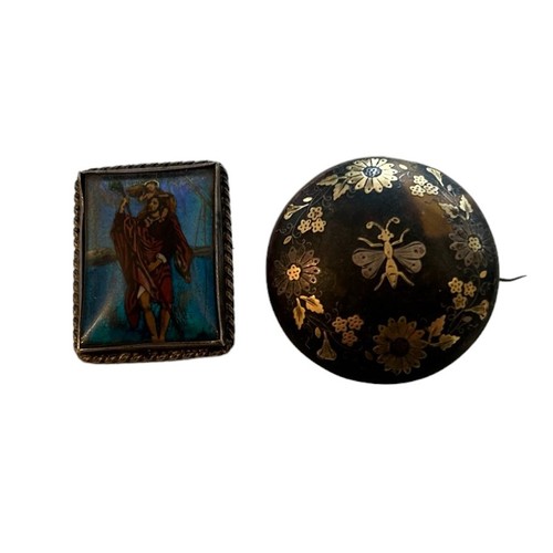 109 - Two Decorative Brooches (2)
A Silver Mounted Butterfly Wing Brooch depicting biblical scene and a go... 