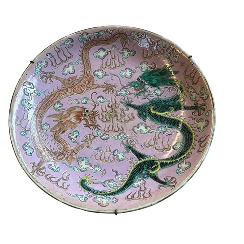 221 - A Large Chinese pink-ground famille rose enamelled 'dragon dish', Kangxi mark and probably of the pe... 