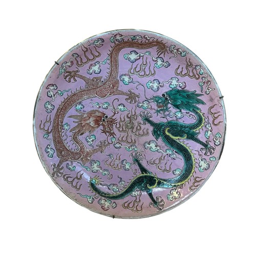 221 - A Large Chinese pink-ground famille rose enamelled 'dragon dish', Kangxi mark and probably of the pe... 