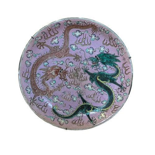 221 - A Large Chinese pink-ground famille rose enamelled 'dragon dish', Kangxi mark and probably of the pe... 