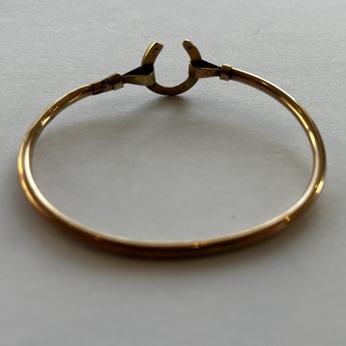 99 - A 9ct Gold Bangle With Horseshoe Detail 4.6g