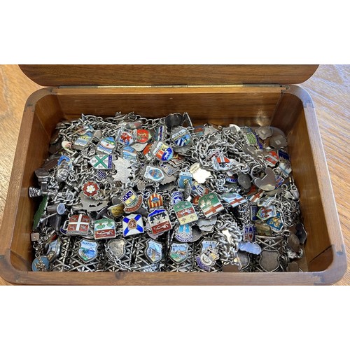 43 - A Box containing approximately 22 silver charm bracelets with a large selection of silver and enamel... 