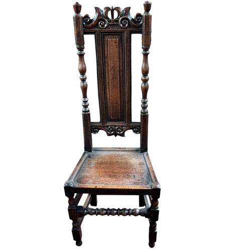 232 - A 17th century style high back dining chair, designed with carved panels and hand turned finials.