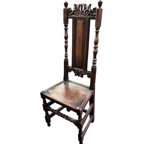 232 - A 17th century style high back dining chair, designed with carved panels and hand turned finials.