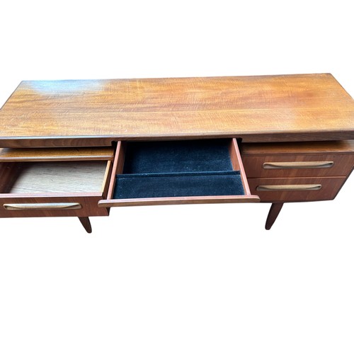 228 - A mid 20th century G-plan teak dressing table, 71cm h x 153cm w, together with a stool