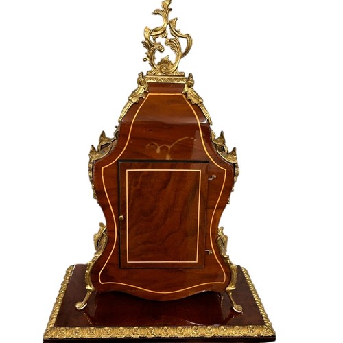 21 - A Louis XIV style 8 day mantel clock by Franz Hermle, gilt metal mounted kingwood case with matching... 