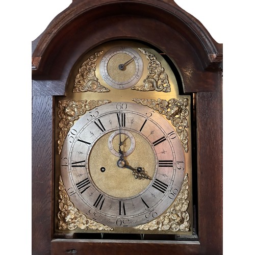 18 - An Oak Cased long case clock, arched brass dial with silvered chapter, subsidiary seconds and date a... 