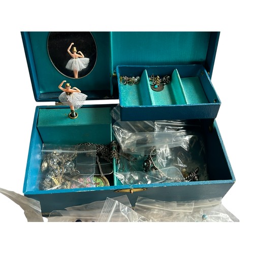 14 - A Musical Jewellery Box containing a collection of Costume / Dress Jewellery