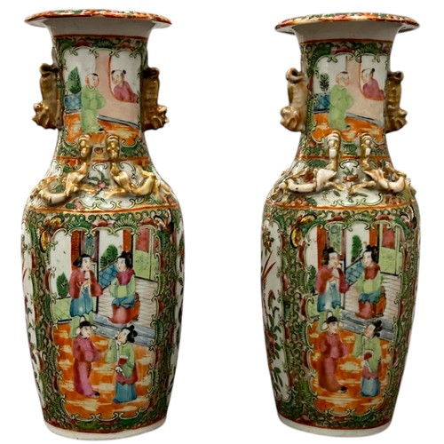 83 - A pair of 19th century Chinese Cantonese Famille Rose vases decorated with Chinese figures.