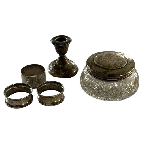 121 - A Quantity of Silver (5) inc three silver Napkin Rings, Silver Topped Glass Jar & a Silver candlesti... 