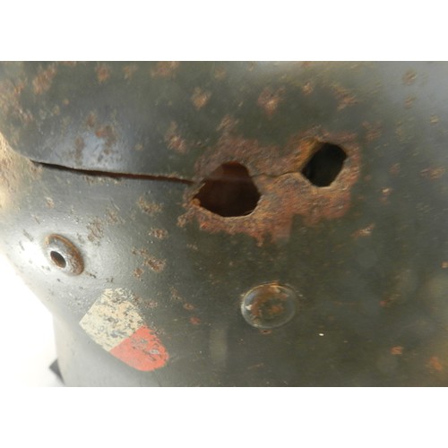 M35 double decal helmet. Some shrapnel damage. Some rust. Defective liner.