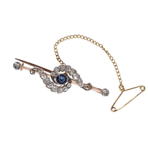 182 - A SAPPHIRE AND DIAMOND BAR BROOCH the collet-set sapphire within a scrollwork of brilliant-cut diamo... 