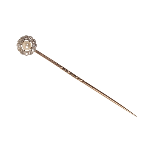 192 - A NATURAL PEARL AND DIAMOND CLUSTER STICK PIN the natural round pearl centered amongst a border of O... 