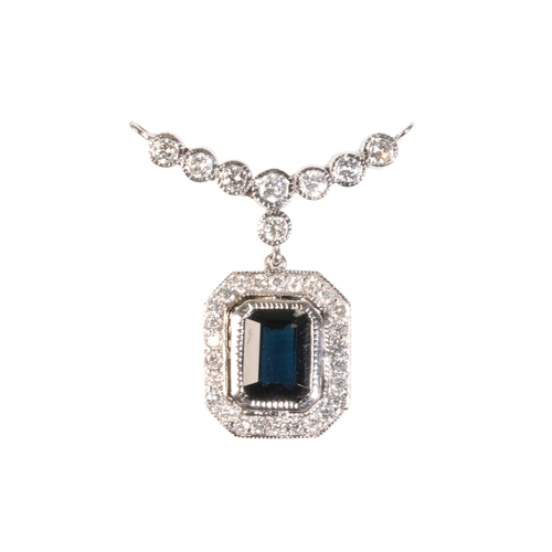 204 - A SAPPHIRE AND DIAMOND PENDANT, the collet-set sapphire, 6mm x 8mm, within a border of brilliant-cut... 