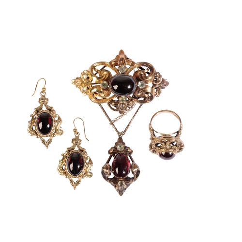 209 - A VICTORIAN GARNET AND UNMARKED YELLOW METAL PENDANT attached by chain to a scrollwork brooch, set t... 