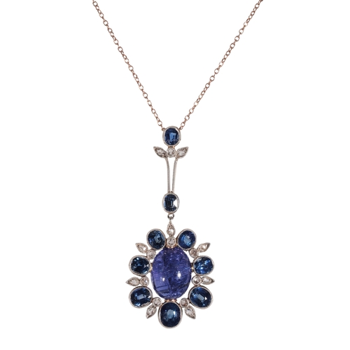 213 - A SAPPHIRE AND DIAMOND NECKLACE the centre cabochon sapphire surrounded by seven graduated sapphires... 