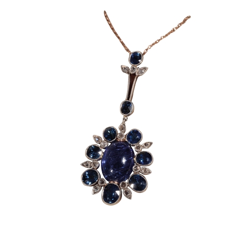 213 - A SAPPHIRE AND DIAMOND NECKLACE the centre cabochon sapphire surrounded by seven graduated sapphires... 