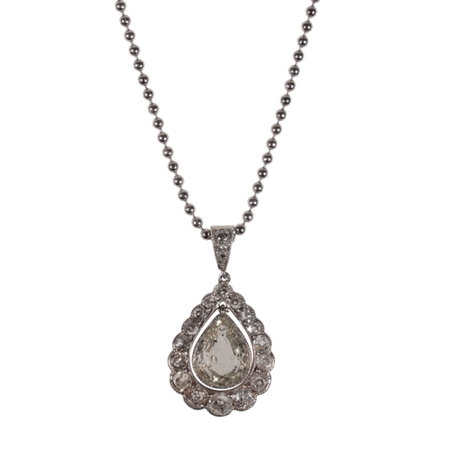 215 - A DIAMOND PENDANT NECKLACE the pear-cut diamond, suspended in an openwork frame of rub-over set diam... 