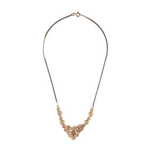 220 - AN 18CT YELLOW GOLD AND DIAMOND NECKLACE three of the flower heads set with a single diamond, attach... 