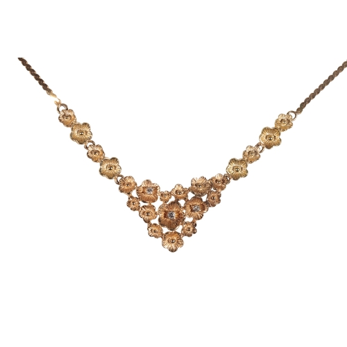 220 - AN 18CT YELLOW GOLD AND DIAMOND NECKLACE three of the flower heads set with a single diamond, attach... 