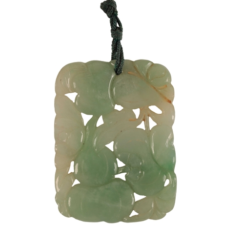 230 - A FINE CARVED JADEITE PENDANT depicting pomegranate fruits and gourds amongst foliage, the pendant 4... 