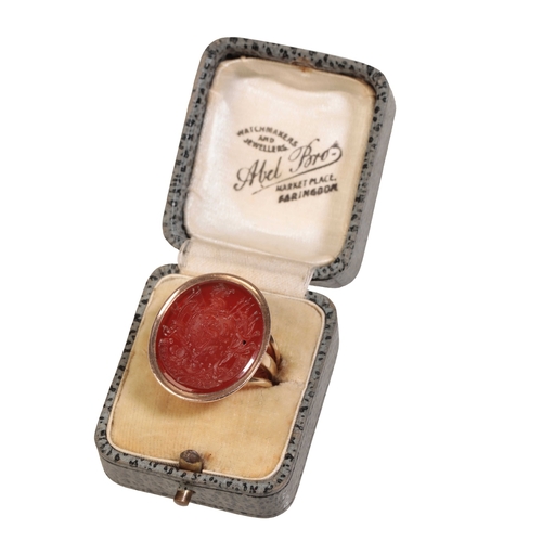 238 - A CARNELIAN INTAGLIO SIGNET RING IN GOLD engraved with an intricate coat of arms centred with lion r... 