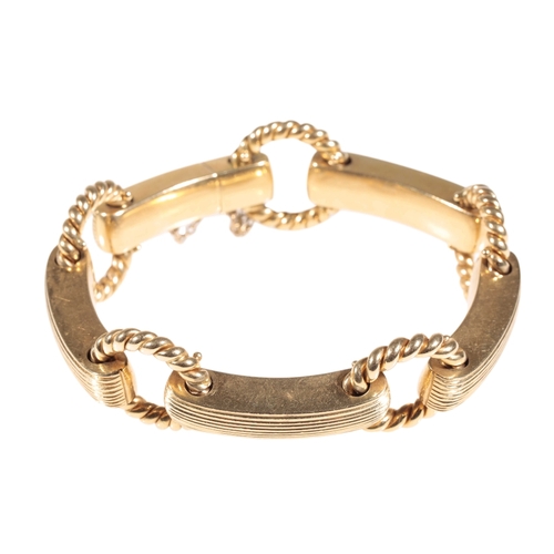 256 - A CHUNKY GOLD BRACELET four curved ribbed and polished links, joined with circular twisted connectio... 