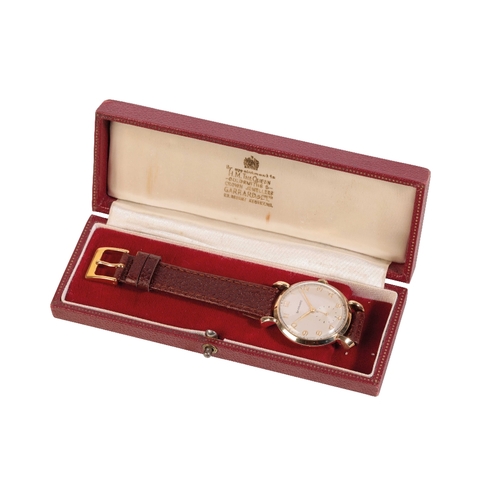 293 - GARRARD 9 CT GOLD GENTLEMAN'S WRIST WATCH with manual wind movement, the silver dial with subsidiary... 