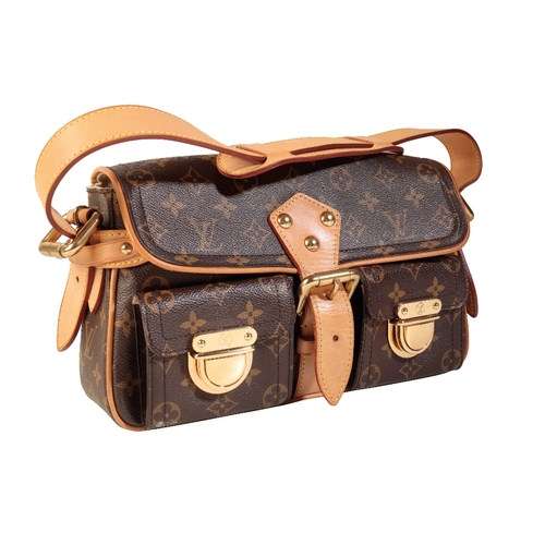 A LOUIS VUITTON MONOGRAMMED HANDBAG, the two front pockets with LV  hardware, buckle fastener, adjust