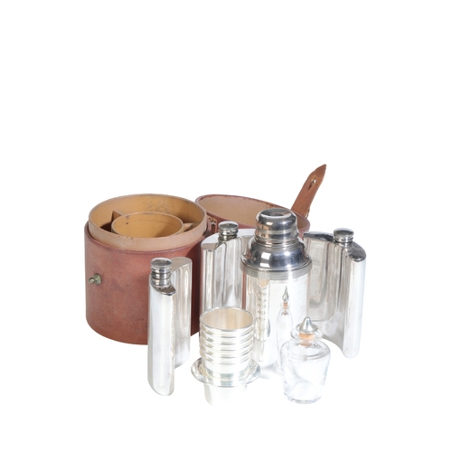 140 - A TRAVELLING COCKTAIL SET including three hipflasks, a cocktail shaker and cups, in a fitted leather... 