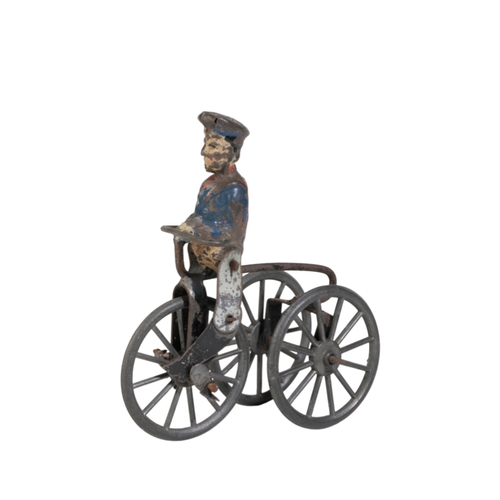 228 - A c.1900 TOY TRICYCLE WITH TINPLATE RIDER the bike measuring 8cm long. Provenance: The Estate of the... 