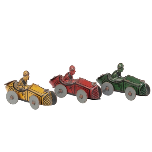 231 - A SET OF THREE 1930'S TINPLATE RACING CARS on a tinplate clockwork track, each car measures 5cm long... 