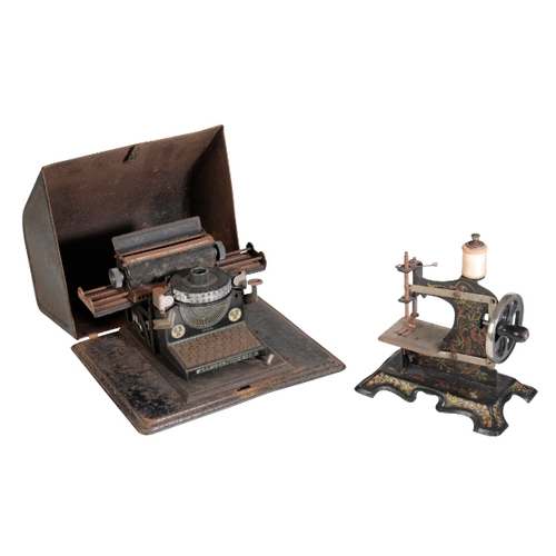 241 - A GERMAN TINPLATE 'U.S.A. PATENTE' CHILDS TYPEWRITING MACHINE TOY the base measuring 23cm across, an... 