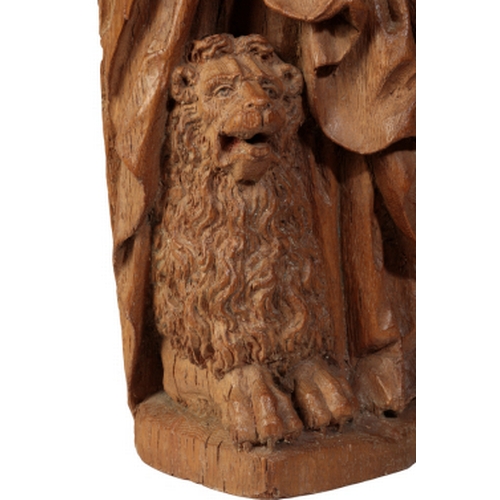 102 - A FRENCH OAK FIGURE OF ST. MARK, circa 1580 standing holding the Bible, a lion at his feet, 88cm hig... 