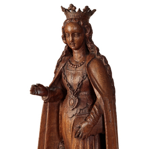 105 - A FLEMISH CARVED OAK FIGURE OF A SAINT, POSSIBLY ST URSULA 16th century, Depicted standing, wearing ... 