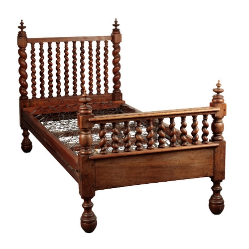 125 - A 17TH CENTURY STYLE WALNUT BED probably Iberian, 19th century, with barley-twist headboard and foot... 