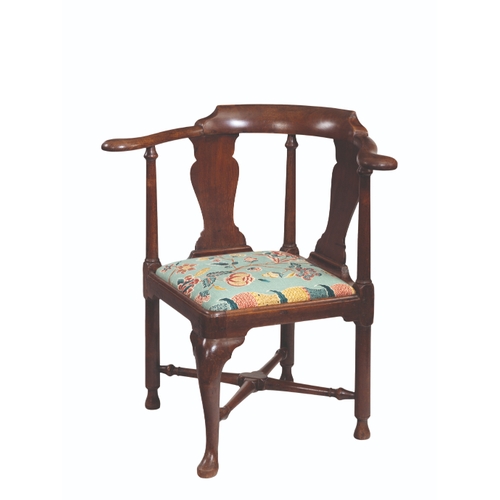 143 - A GEORGE II WALNUT CORNER CHAIR with twin vase-shaped splats and bold outscroll arms on columnar-tur... 