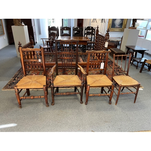 131 - A SPINDLE BACK ARMCHAIR  OF LANCASHIRE TYPE with rush seat, together with three single chairs with r... 