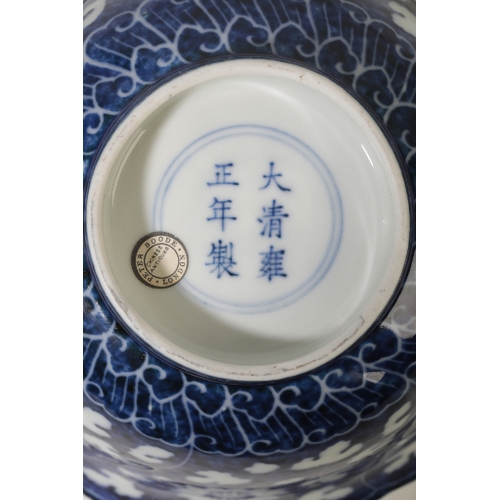 19 - A CHINESE BOWL with an undulating rim and a slightly flared body decorated in white with floral spra... 