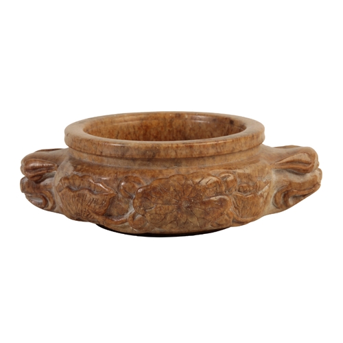63 - A CHINESE SOAPSTONE CENSER in finely mottled stone of amber colour, the compressed circular body car... 