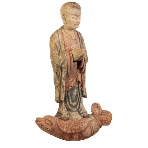 65 - A CHINESE CARVED WOOD AND POLYCHROME LOHAN, PROBABLY LATE MING, modelled riding on the back of a fis... 