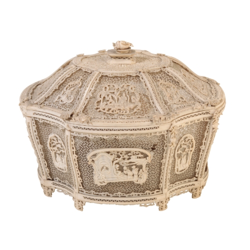 73 - A CHINESE IVORY BASKET of shaped form finely carved and pierced with panels of figures, on a complex... 