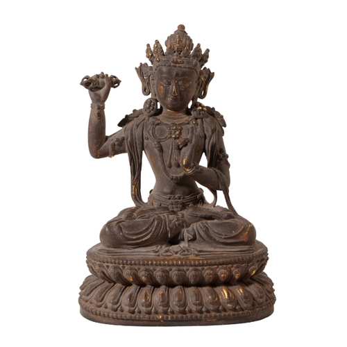 82 - A SINO-TIBETAN BRONZE BUDDHA the figure seated cross legged with right arm raised on a stylised lotu... 