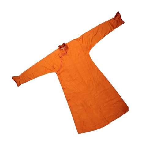 89 - A TIBETAN WARRIORS ORANGE ROBE buttoned at the side and with flared cuffs, 195cm wide across the sho... 